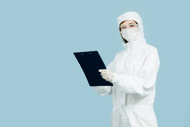 istock Doctor in a white costume making notes in a clipboard. 1264838212