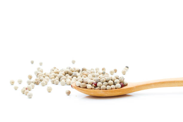 istock Pepper spices in a wooden spoon on a white background 1264839104