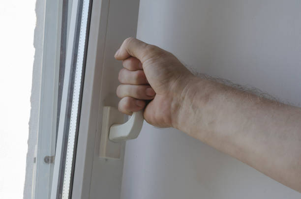 istock Male hand opens the window by the handle. 1264839597