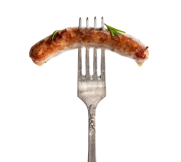 cooked sausage chipolatas on a fork isolated on white background - sausage bratwurst barbecue grill barbecue imagens e fotografias de stock