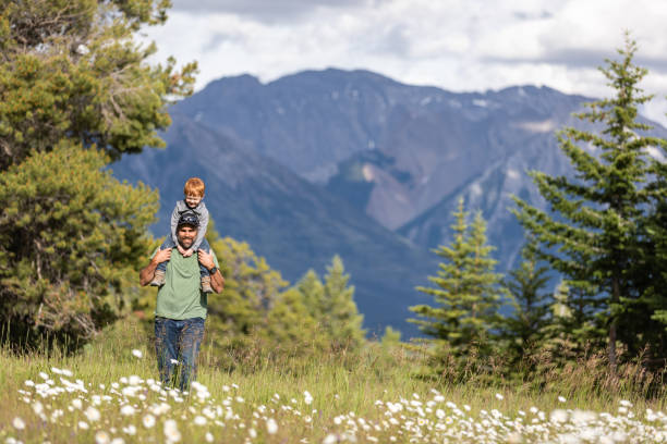 istock Father carrying his Son on Shoulders in Mountains 1264840943