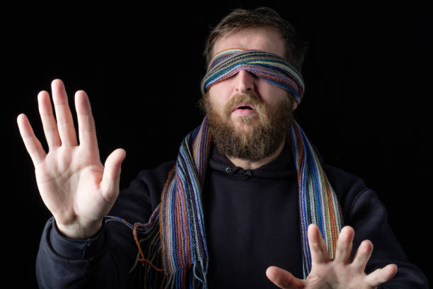 istock a man with a blindfold put his hands forward so as not to bump into an obstacle 1264841726