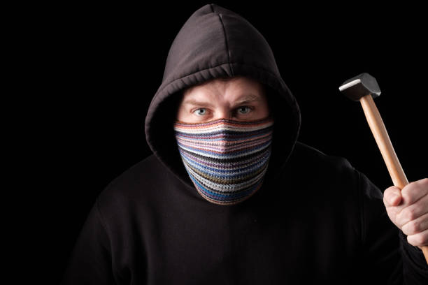 istock aggressive white man with a bandage on his face and a hammer in his hand. aggression is associated with the global crisis and unemployment 1264841743