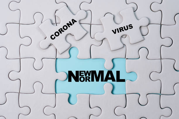 istock Corona virus wording print screen on white jigsaw puzzle which after open will see new normal wording. COVID-19 and new normal crisis concept. 1264842154