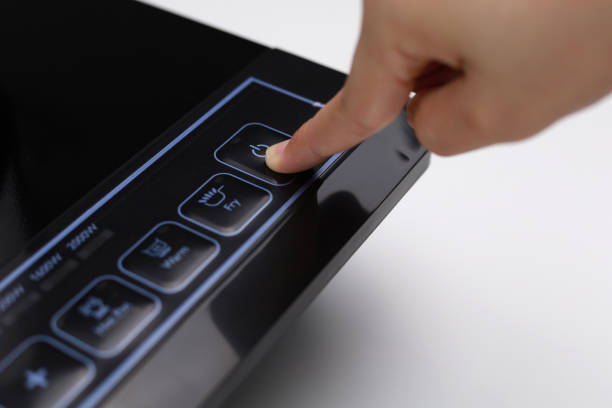 istock Female hand using the control slider on the induction hob 1264842384