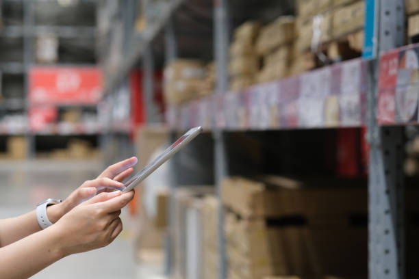istock close up hands using tablet with blurred goods shelf in warehouse, store concept 1264843033