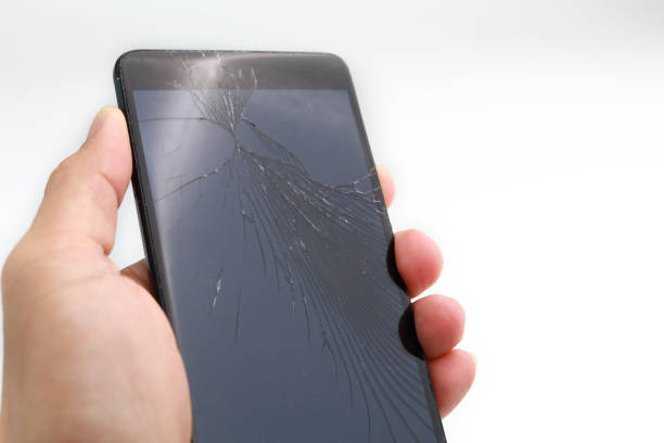 istock Mobile phone with broken display glass on a white background 1264843129