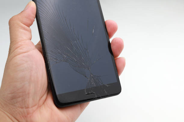 istock Mobile phone with broken display glass on a white background 1264843138