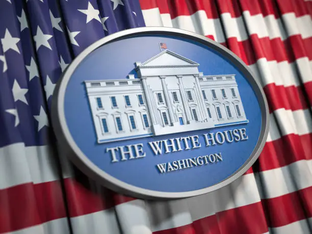 Photo of The White House Washington sign on flag of United States USA.