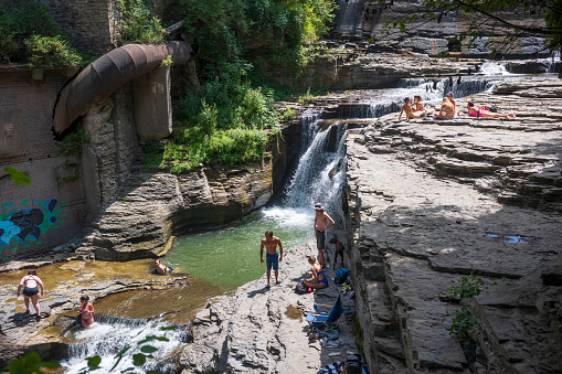 Ithaca, NY/USA-Aug 2, 2020: Groups of people to escape the summer heat by bathing in natural pools of water at Six Mile Creek park.  Local, state and federal parks are a popular attraction this year.