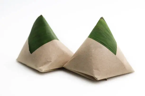 Photo of Nasi lemak wrapped in paper and banana leaf