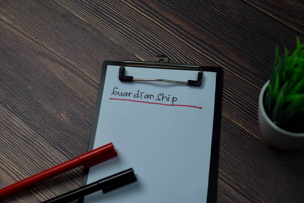istock Guardianship write on paperwork isolated on wooden table. 1264845772
