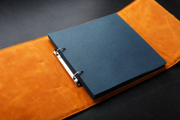 istock Photo album with empty space for photos, white frames on black paper. 1264847080