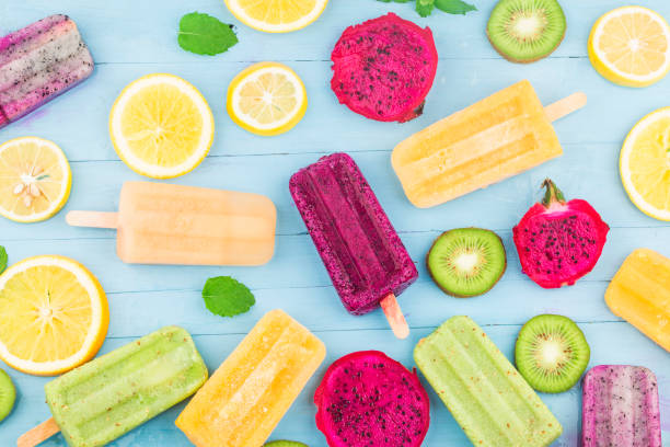 istock Various fruit popsicles are placed on the blue wooden board background, kiwi popsicles, orange popsicles, dragon fruit popsicles, cantaloupe popsicle 1264847123