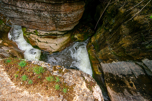 Beautiful mountain waterfall bouncing from the red massive rock, Serbia