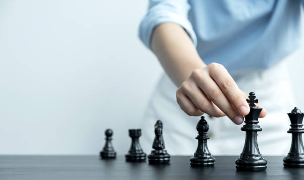 istock hand move chess with strategy and tactic to win enemy, play battle on board game, business opportunity  competition strategic challenge concept 1264850880
