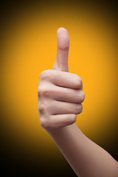 istock Woman's hand showing thumbs up gesture. isolated on gradient background. Hand sign concept. 1264851065