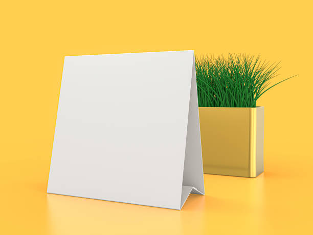 istock Blank paper Table Tent. Mockup on yellow background. 3D illustration. 1264852229