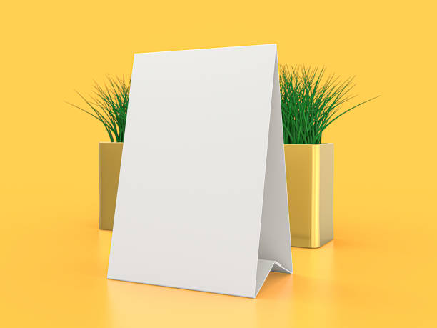 istock Blank paper Table Tent. Mockup on yellow background. 3D illustration. 1264852233
