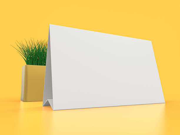 istock Blank paper Table Tent. Mockup on yellow background. 3D illustration. 1264852235