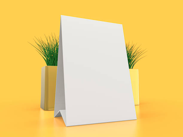 istock Blank paper Table Tent. Mockup on yellow background. 3D illustration. 1264852236