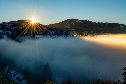 Fag filled valley below a beautiful sunburst