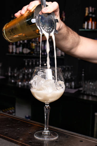 istock The bartender pours a foaming cocktail into the glass. 1264854469