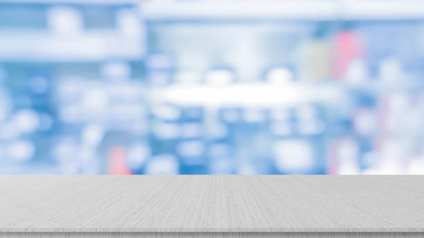 istock abstract blurred drug store aisle shelf distribution background with white marble perspective counter to show,promote,advertise on display for medical pharmaceutical business concept 1264854535