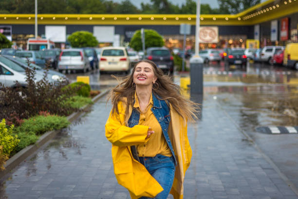 istock Young woman running in the rain 1264855561