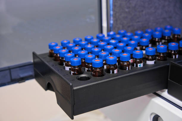 istock Glass vials with blue caps are in the rack of HPLC system with autosampler. Separation of compounds at chemical or clinical laboratory. Scientific and research work. Development of pharmaceuticals. 1264857504