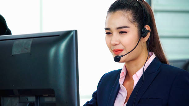 istock Business people wearing headset working in office 1264858013