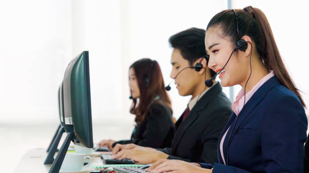 istock Business people wearing headset working in office 1264859049
