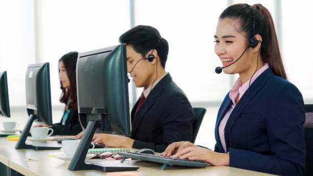 istock Business people wearing headset working in office 1264859849