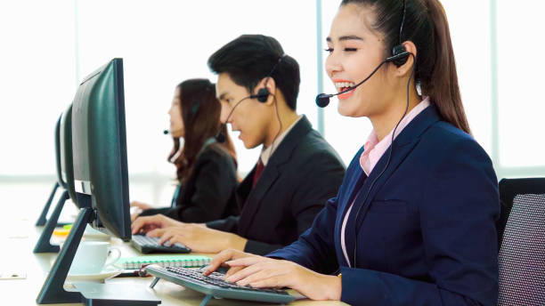 istock Business people wearing headset working in office 1264860228