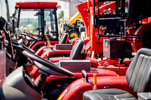 Rows of modern tractors. Industrial details. Agricultural exhibition