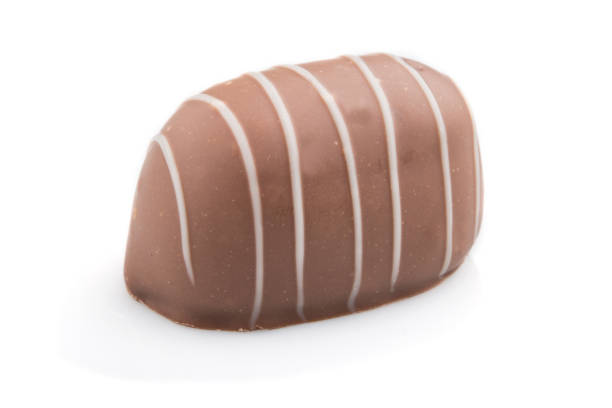 istock Single chocolate candy isolated on white background. side view, close up. 1264860303