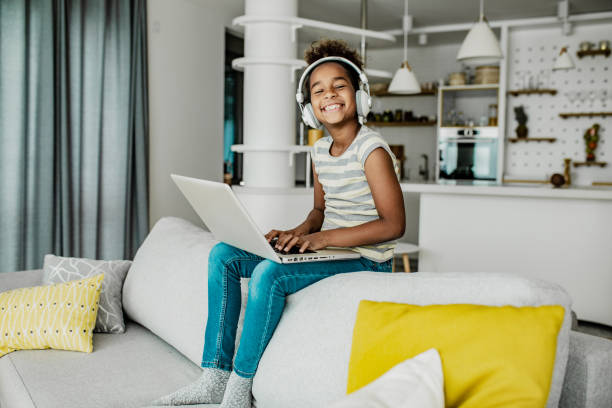 istock Young African American girl at home using laptop 1264860706