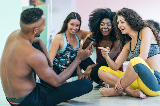 istock Group of dancers sitting and rest on floor and using smart phone 1264865157