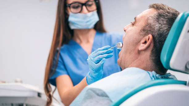 istock Mid adult man having teeth examined at dentists 1264865193