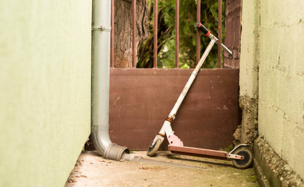 istock old abandoned scooter stands leaning against a metal gate 1264865944