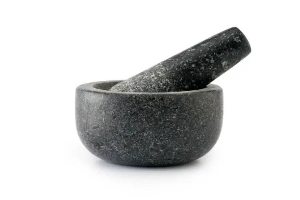 Stone mortar and pestle on a white background
