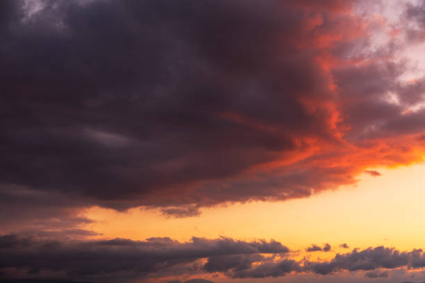 Beautiful bright sunset sky. Dramatic colorful clouds after sunset. Nature, sunset clouds backgrounds.