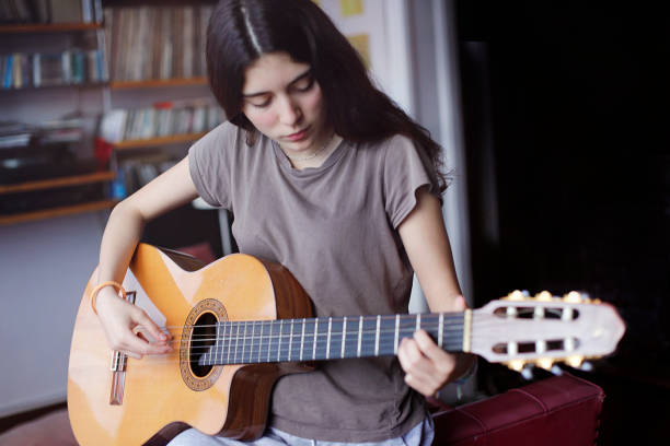 istock young girl playing guitar 1264869572