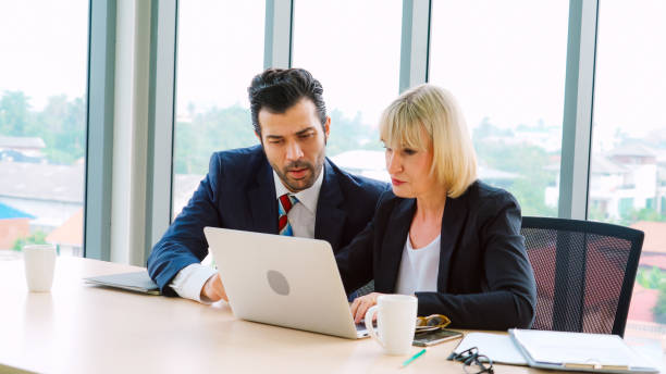 istock Two business people talk project strategy at office 1264870674