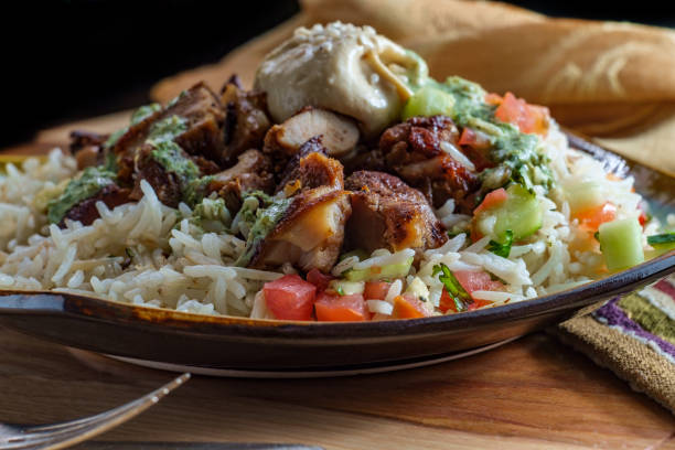 Middle Eastern Chicken Shawarma Authentic Middle Eastern chicken Shawarma rice platter with hummus and side salad shawarma stock pictures, royalty-free photos & images