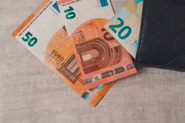 istock Euro banknotes in leather wallet on light background. 1264870978