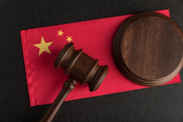 Judge gavel on the China flag. Law and legality in PRC. Violation of human rights Judge gavel on the China flag. Law and legality in PRC. Violation of human rights. prc stock pictures, royalty-free photos & images