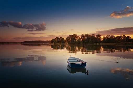 Rowing boat floating over the Elckie Lake waters. Masuria, Poland.
