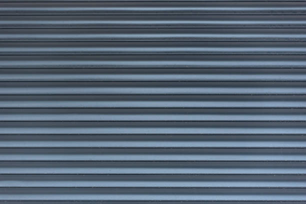 Metal blinds. Grey abstract background in line. Light and shadow. Textured surface