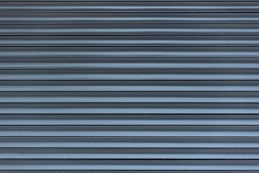 Metal blinds. Grey abstract background in line. Light and shadow. Textured surface.
